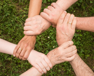 Closeup of 5 people holding hands